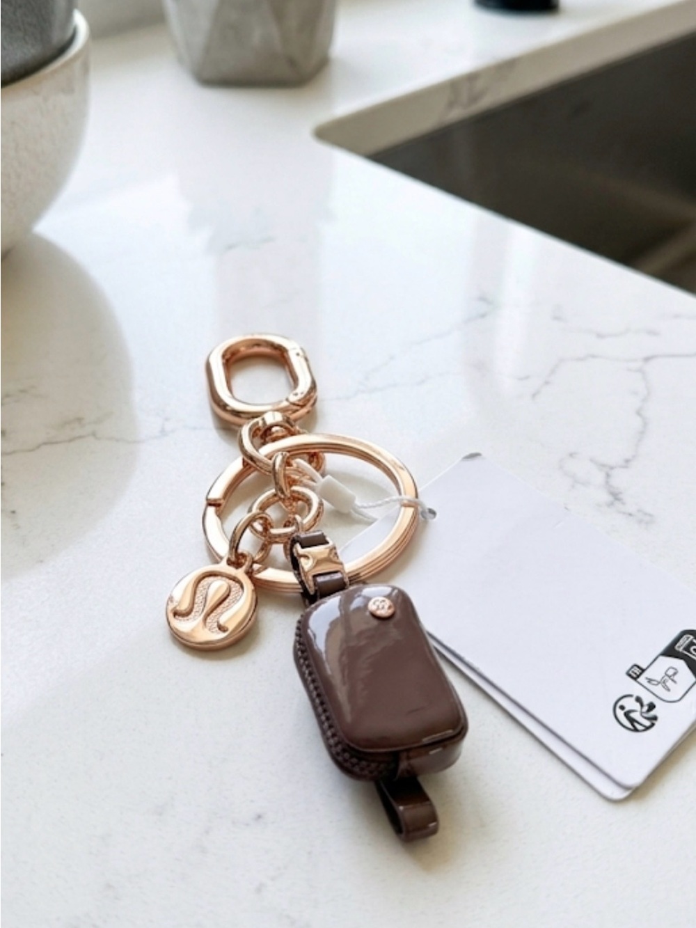 Lululemon Everywhere Belt Bag Charm in a deep plum color with gold